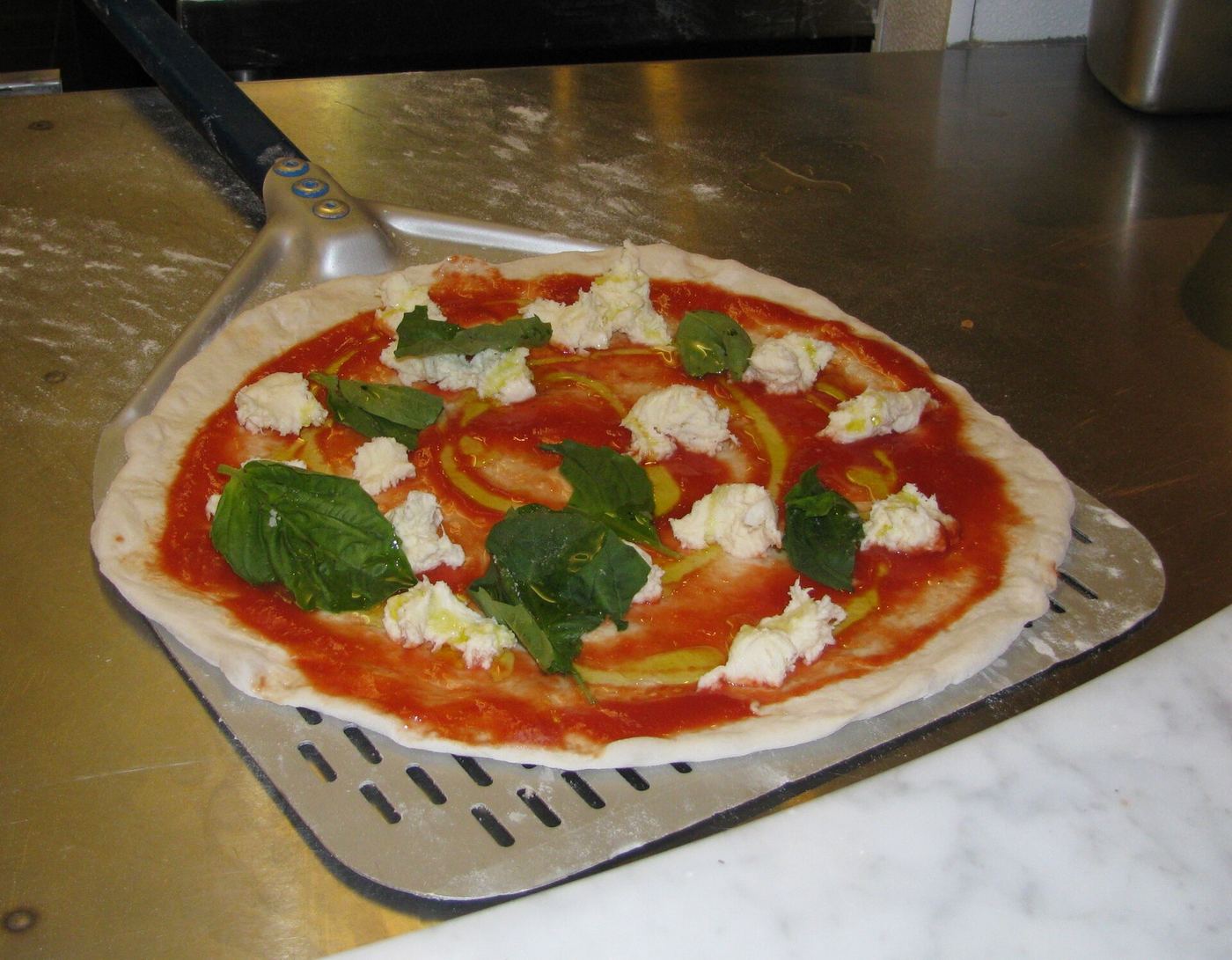 Two pizzas on a peel